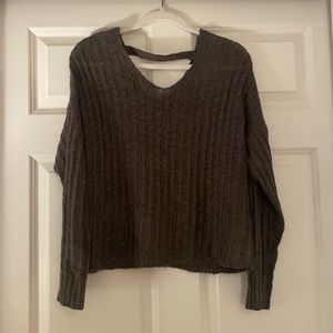 green v-neck sweater cropped in front a bit longer in back